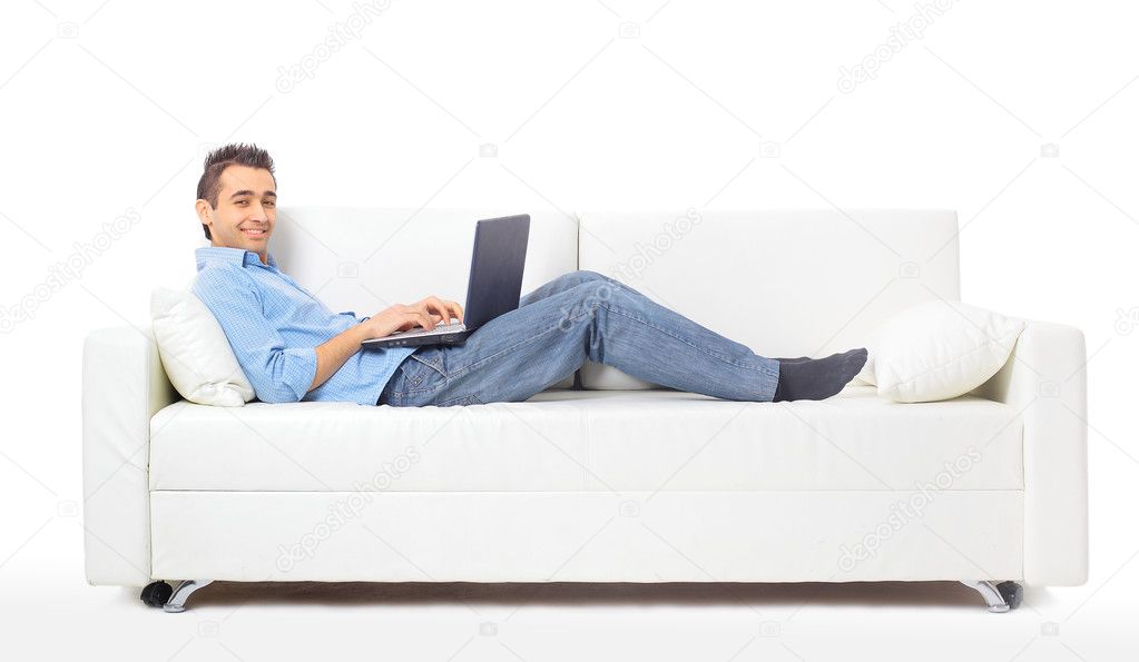 depositphotos_5261477-Happy-man-working-on-his-laptop-on-the-sofa-at-home.jpg