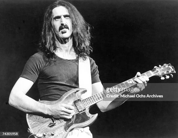 rock-and-roll-guitarist-frank-zappa-plays-a-gibson-sg-electric-guitar-picture-id74301958
